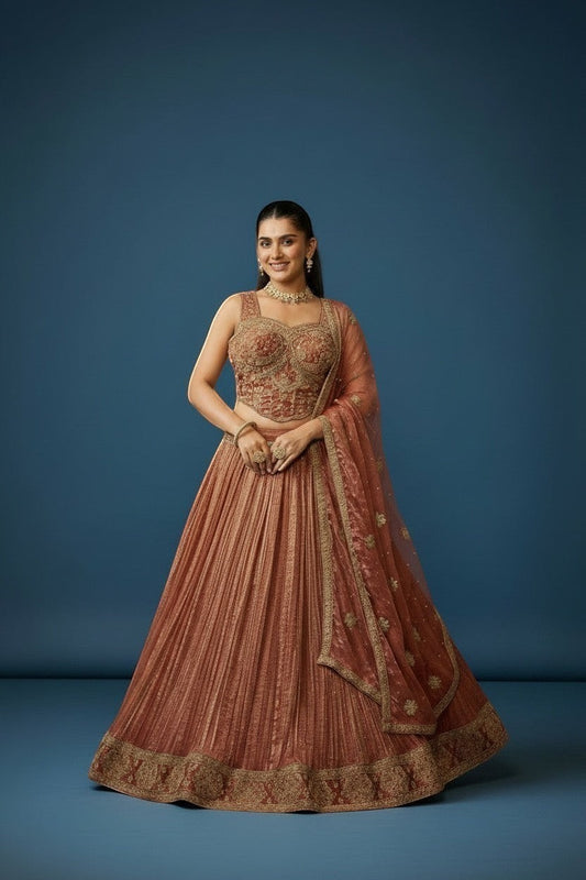 Kurti Connection USA embroidered lehenga and blouse set in warm rust with gold detailing. Sleeveless blouse and pleated skirt.