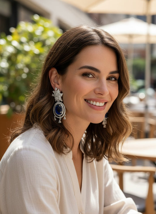 Kurti Connection USA ornate silver drop earrings with blue carved stones and clear cubic zirconia accents.