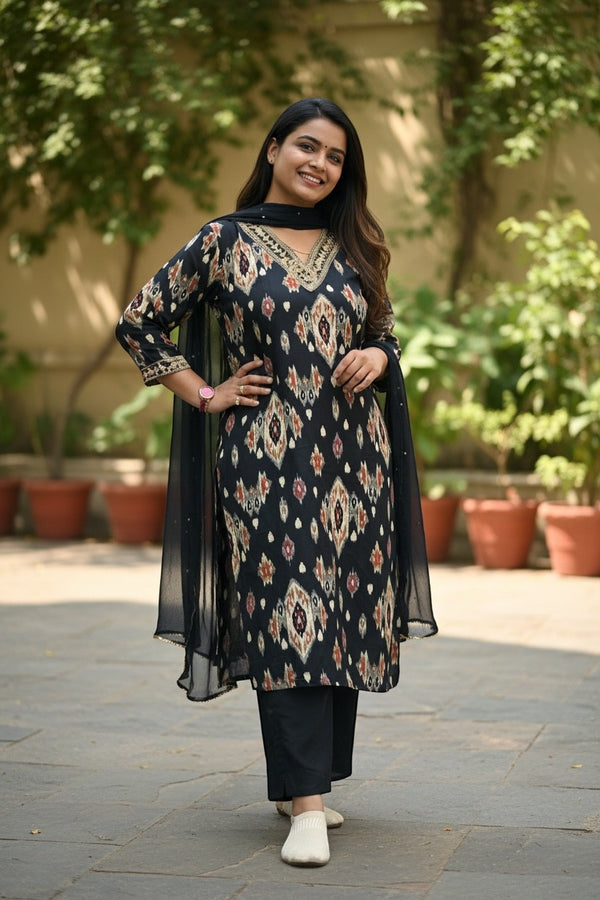Kurti Connection USA black ikat print kurta with gold neckline, black pants, and sheer dupatta. Woman smiling outdoors.