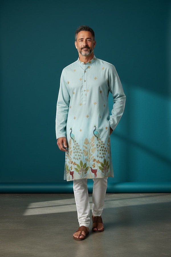 Kurti Connection USA light blue silk kurta set with intricate peacock and deer embroidery, paired with white pajama.