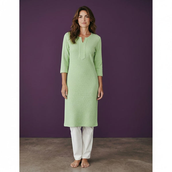 Kurti Connection USA light green textured cotton kurti with 3/4 sleeves and V-neck. Model is barefoot against a purple backdrop.