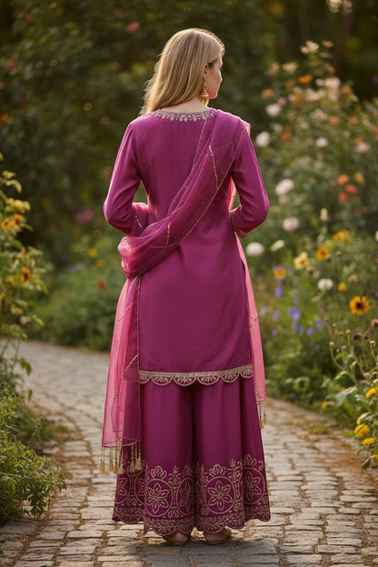 Kurti Connection USA magenta silk sharara suit with gold embroidery and scalloped hem. Model wears it outdoors.